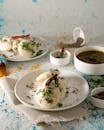 Delicious South Indian idli served with spices and chutney on a rustic background.